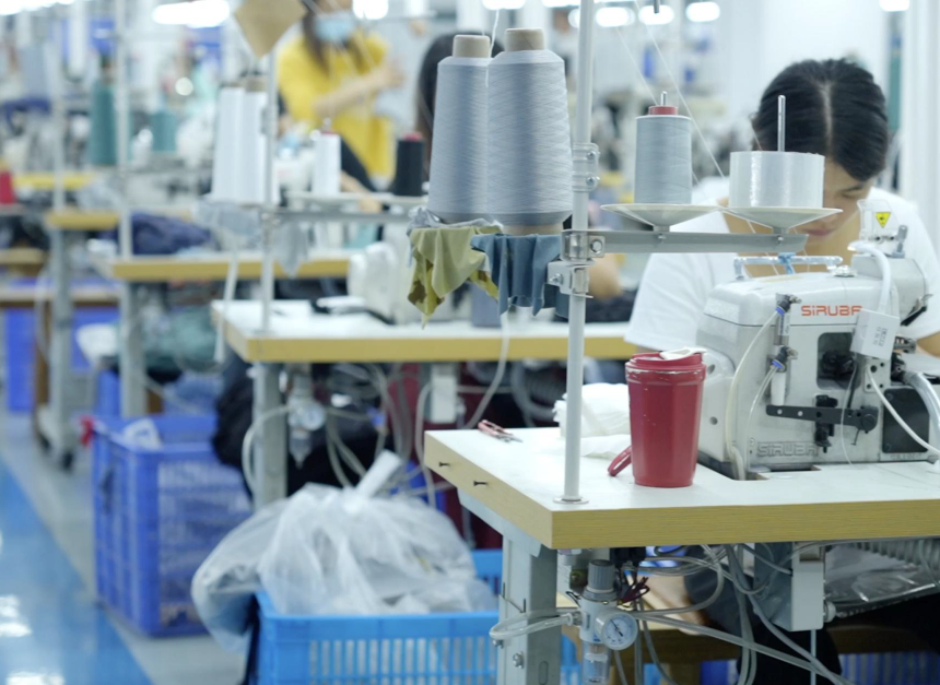Specialized four-needle six-thread sewing machine in operation