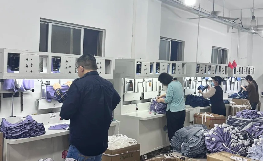 QC inspector measuring waistband under standard light source