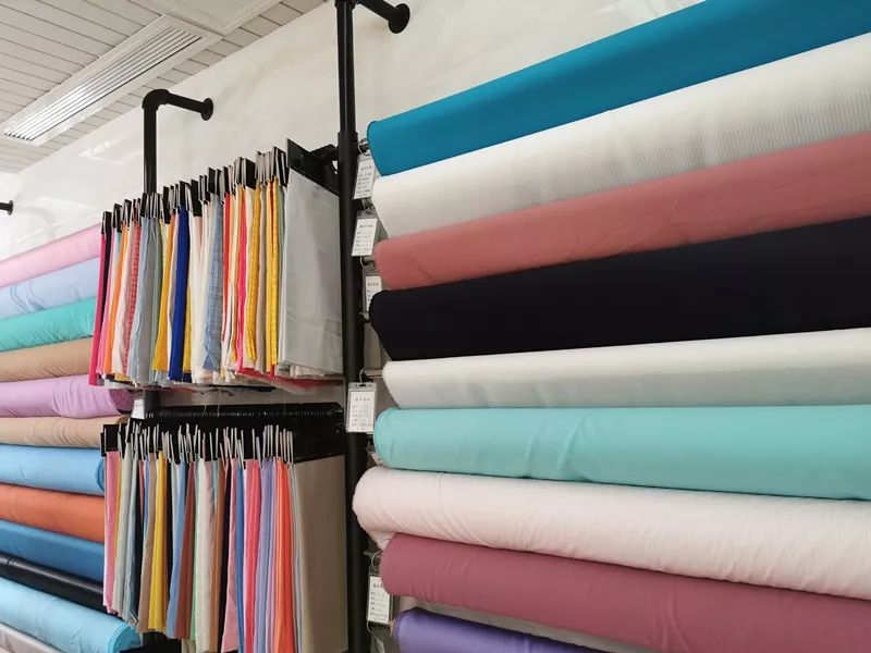 Sunlit workshop and shelves of organic cotton, bamboo and recycled nylon